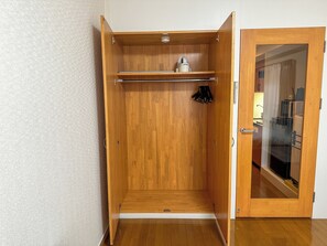 A wooden wardrobe with a hanging rod and a small shelf. - goom Hotel Hakata Minoshima (Fukuoka City Hakata ku Minoshima)