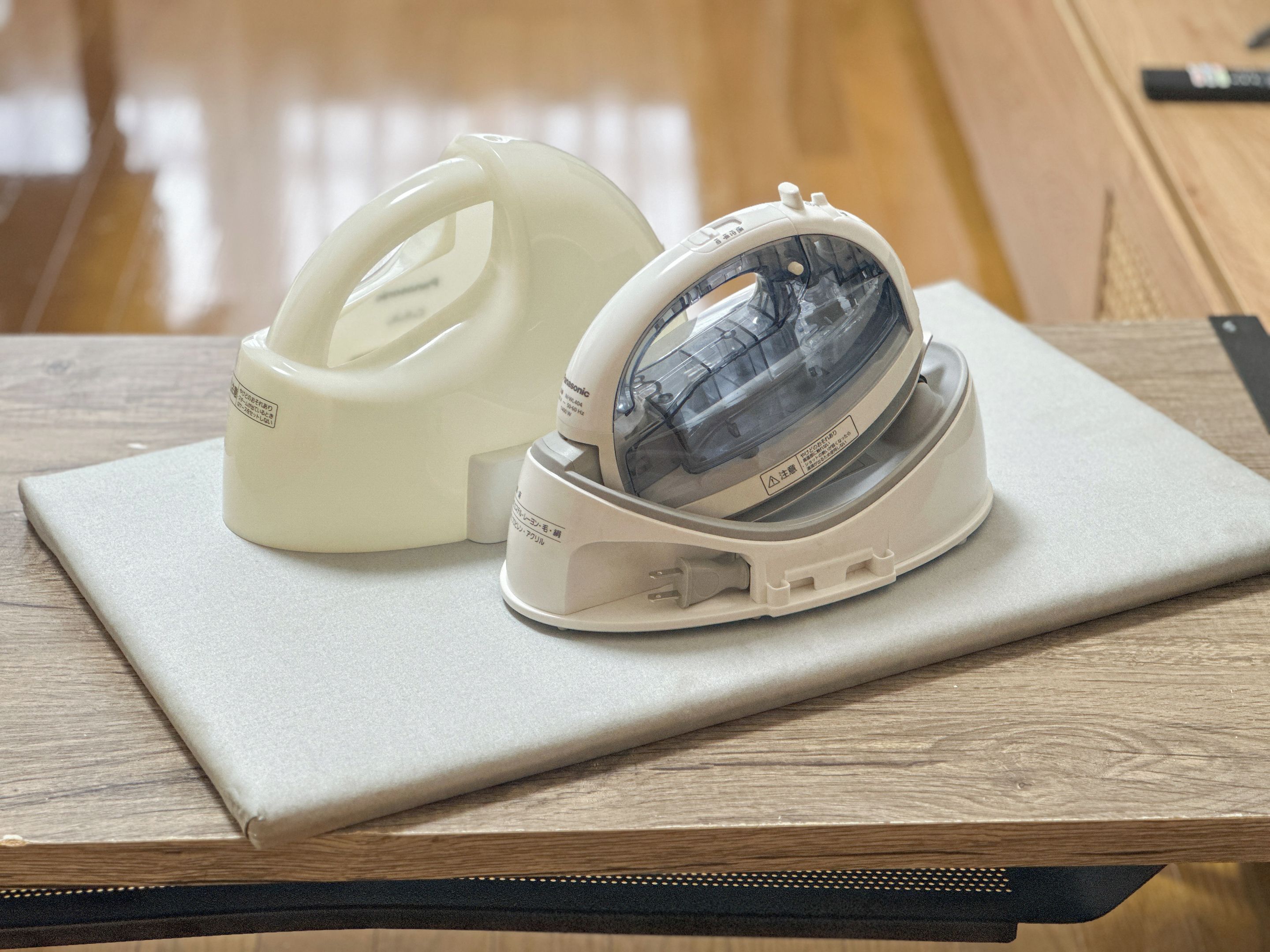 A tape dispenser and a stapler on a wooden table.