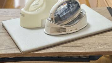 A tape dispenser and a stapler on a wooden table.