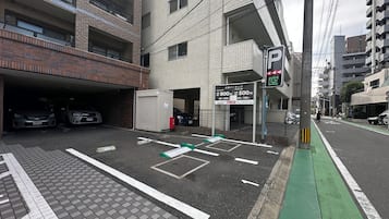 A parking garage entrance with a sign indicating parking rates.