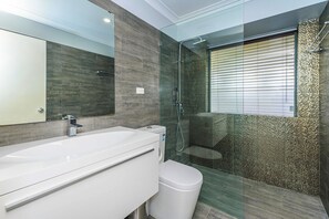 A modern bathroom with a large white sink, a toilet, and a glass-enclosed shower area. - Modern Home near Swan Valley (Beechboro)