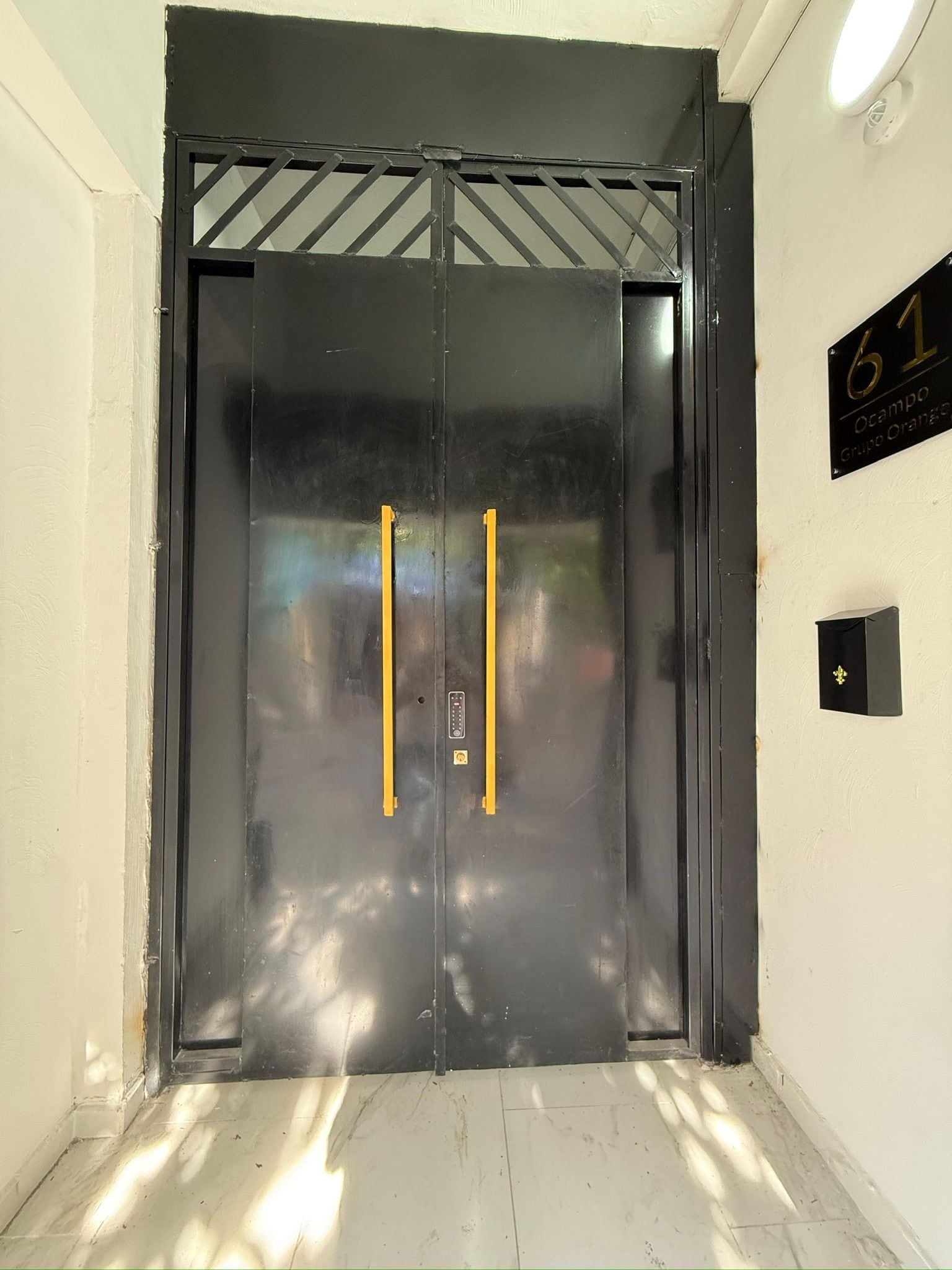 A black elevator door with a number '61' sign above it.