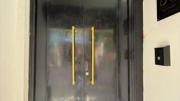 A black elevator door with a number '61' sign above it.