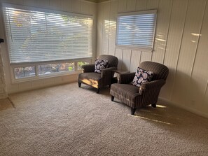 A room with two striped armchairs, a small table, and a carpeted floor. -     Cozy 3BR Monterey Retreat – Close to Beach & Attractions (Monterey)