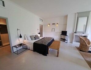 A modern bedroom with a bed, bedside tables, a chair, a television, and a fireplace. - Gorgeous 18th-century Villa, Maillane (Maillane)
