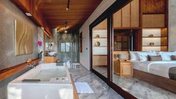 Un baño moderno con una bañera grande, ducha y tocador.