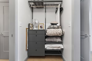A compact storage unit with a fan, a mirror, and a set of drawers.