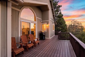 A wooden deck with outdoor seating and a barbecue grill. - Pool + Hot Tub + Gym | Near Village + Trails | Poolside Pines Reunion House (Lake Arrowhead)