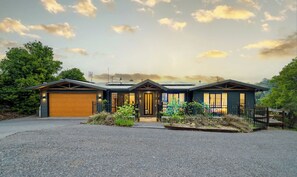 A two-story house with a garage, a front porch, and a driveway. - Fletchers Ridge House (Montville)