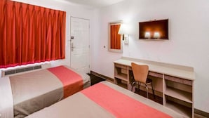 A hotel room with two beds, a desk, a chair, a television, and a door. - Spacious 2-bed Room|Pool|Free Wifi (Bellingham)