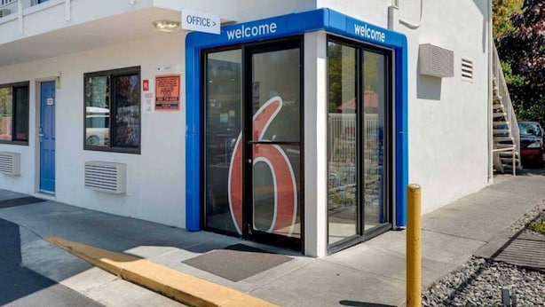 A building with a blue entrance marked 'office' and 'welcome'. - Spacious 2-bed Room|Pool|Free Wifi (Bellingham)