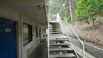 A building with a blue door marked '135' and a staircase leading to an upper level.