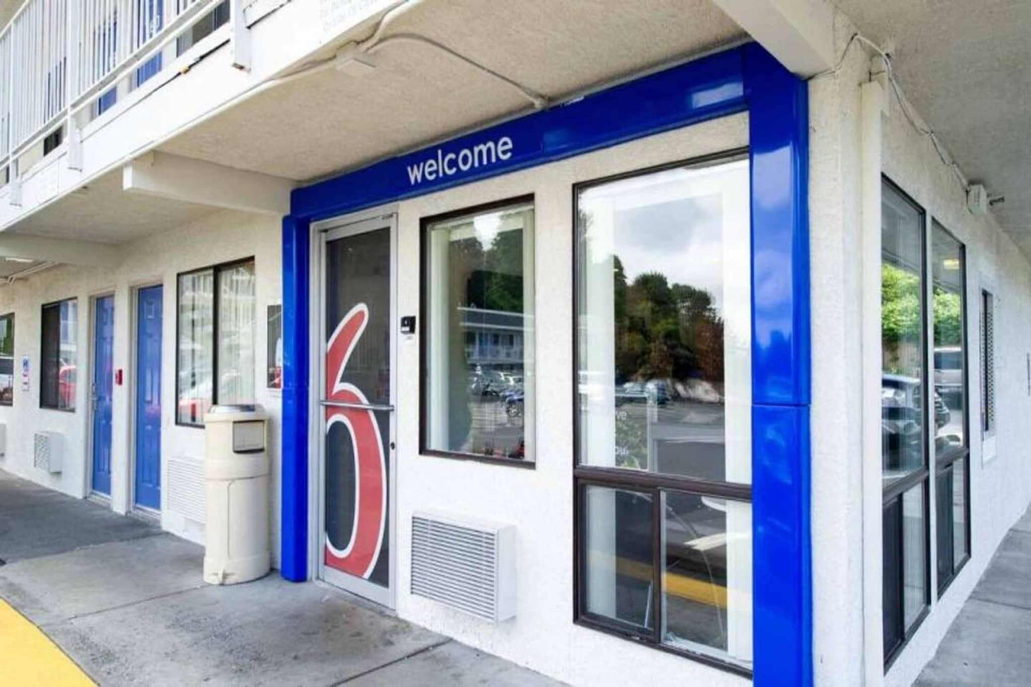 A building with a 'welcome' sign, large windows, and a blue and white color scheme.