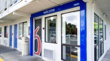 A building with a 'welcome' sign, large windows, and a blue and white color scheme.