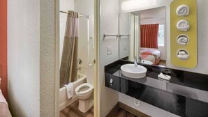 A hotel bathroom with a toilet, sink, and mirror. - 2 Full Beds | Non-Smoking (Everett)