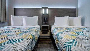 A hotel room with two beds, a nightstand, and a wall-mounted phone. - 2 Full bed | Richland (Richland)