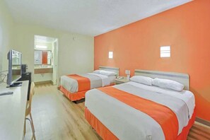 A hotel room with two beds, a desk, and a television. - 2 Queen Beds | Smoking (Maple Shade)