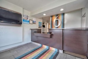 A reception area with a counter, a large number '6' sign, and a striped carpet. - Spacious King Bed|Pool|Free Parking (Albuquerque NM)