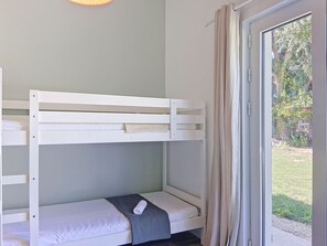 A bunk bed with a small table and a window with curtains. - Les Salines by Interhome (Ile d'Oléron)