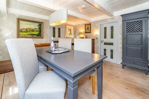 Ein Essbereich mit Tisch, Stühlen und einem Schrank.