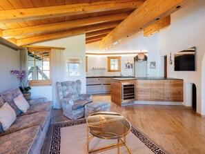 Un salon moderne avec un canapé, une table basse et un tapis à motifs.
