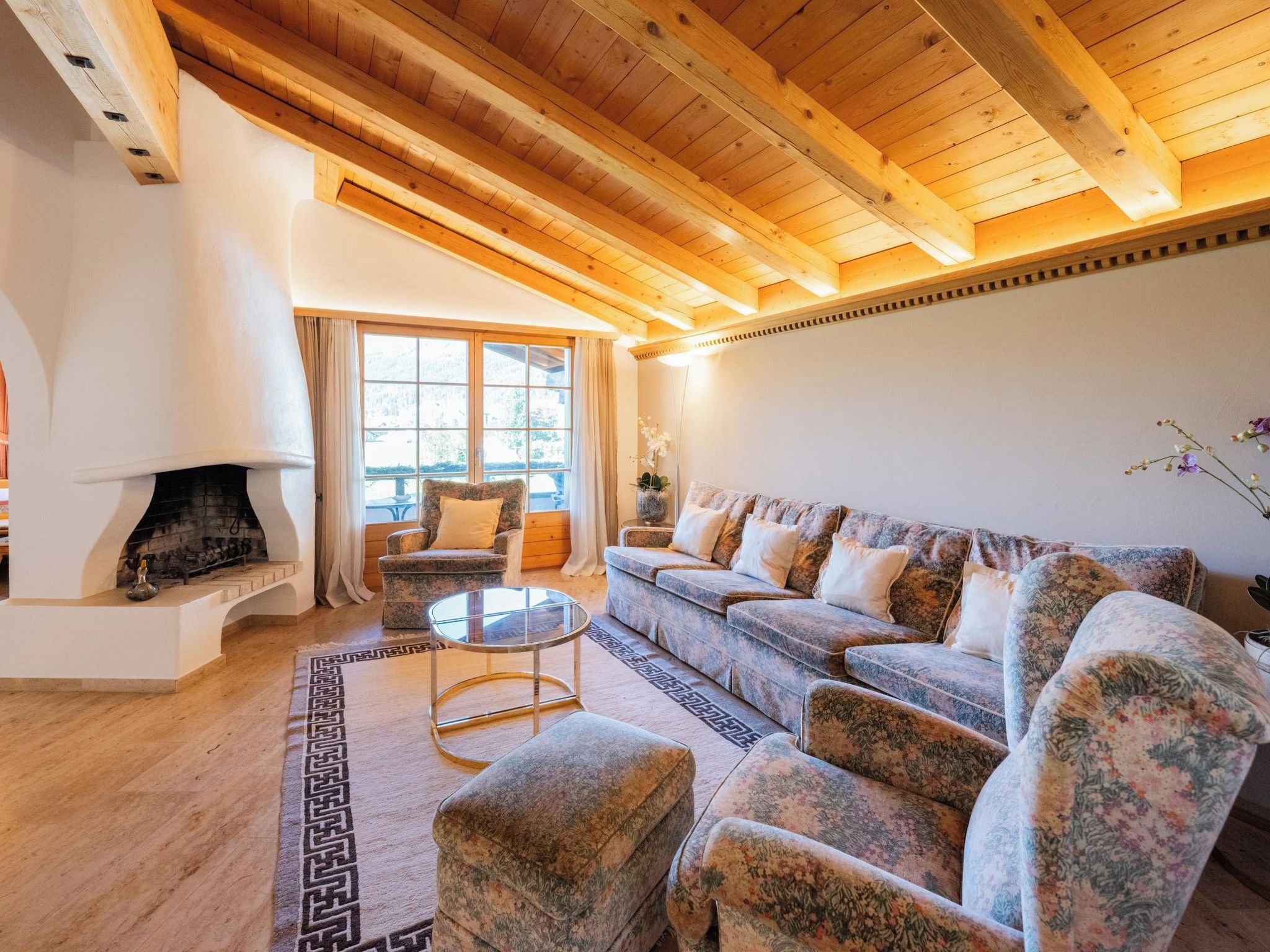 A cozy living room with a fireplace, a sofa set, and a coffee table.