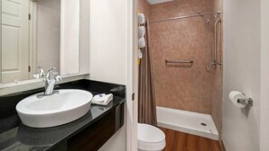 A bathroom with a white sink, a toilet, and a shower area. - 2 Queen Beds|Mobil Access Tub NS Micfridge (Ilion)