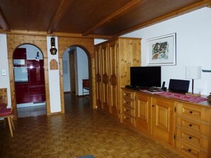 A wooden interior with a TV, a desk, and a chair. - Chlus 1 Appartement/Fewo, Dusche oder Bad, WC 2 1/2-Zimmerwohnung by Interhome (Klosters)