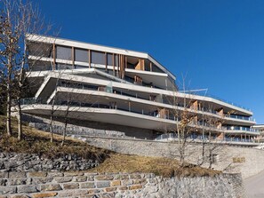 A multi-story building with a modern architectural design, featuring balconies and large windows. - Scarlett Suot 64 Appartement/Fewo, Dusche oder Bad, WC 4-Zimmerwohnung by Interhome (Davos)