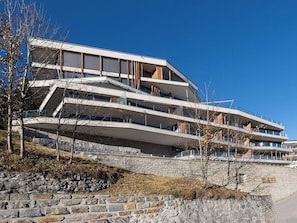 A multi-story building with a modern architectural design, featuring balconies and large windows. - Scarlett Suot 63 Appartement/Fewo, Dusche oder Bad, WC 4-Zimmerwohnung by Interhome (Davos)