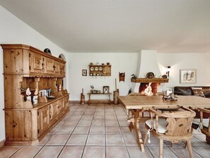 A traditional interior with a wooden cabinet, a fireplace, and a dining table. - Cresta 5 Appartement/Fewo, Dusche oder Bad, WC 4 1/2-Zimmerwohnung by Interhome (Klosters)
