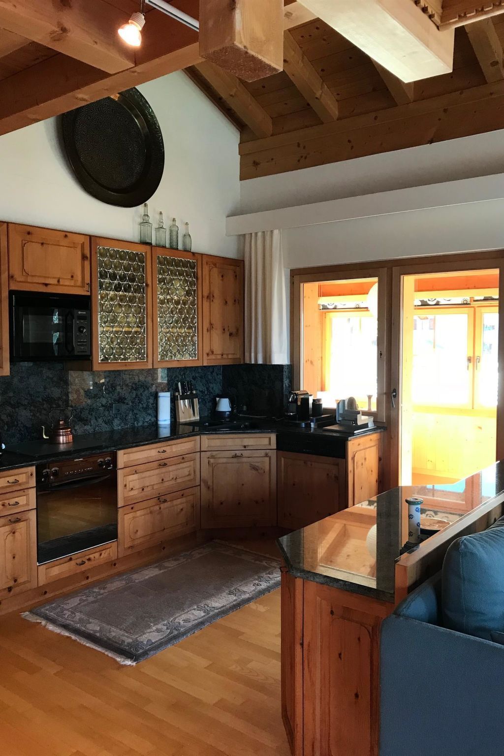 A kitchen with wooden cabinets, a microwave, and a coffee machine.