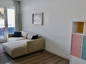 A room with a beige sofa, a framed picture on the wall, and a multi-colored cabinet. - M Köhler Appartement/Fewo, Dusche oder Bad, WC 1-Zimmerwohnung by Interhome (Davos)