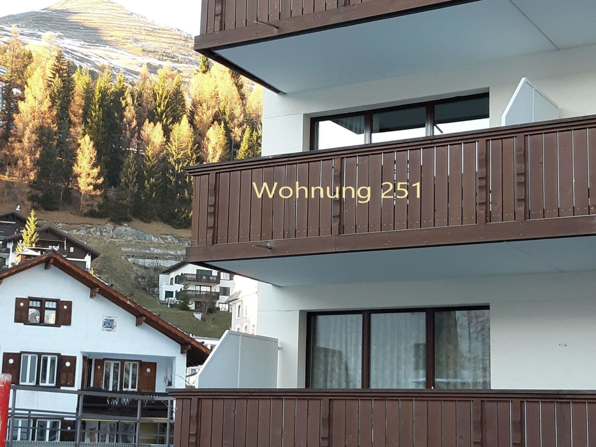 Ein mehrstöckiges Gebäude mit einem Balkon und einem Schild, auf dem 'Wohnung 251' steht.