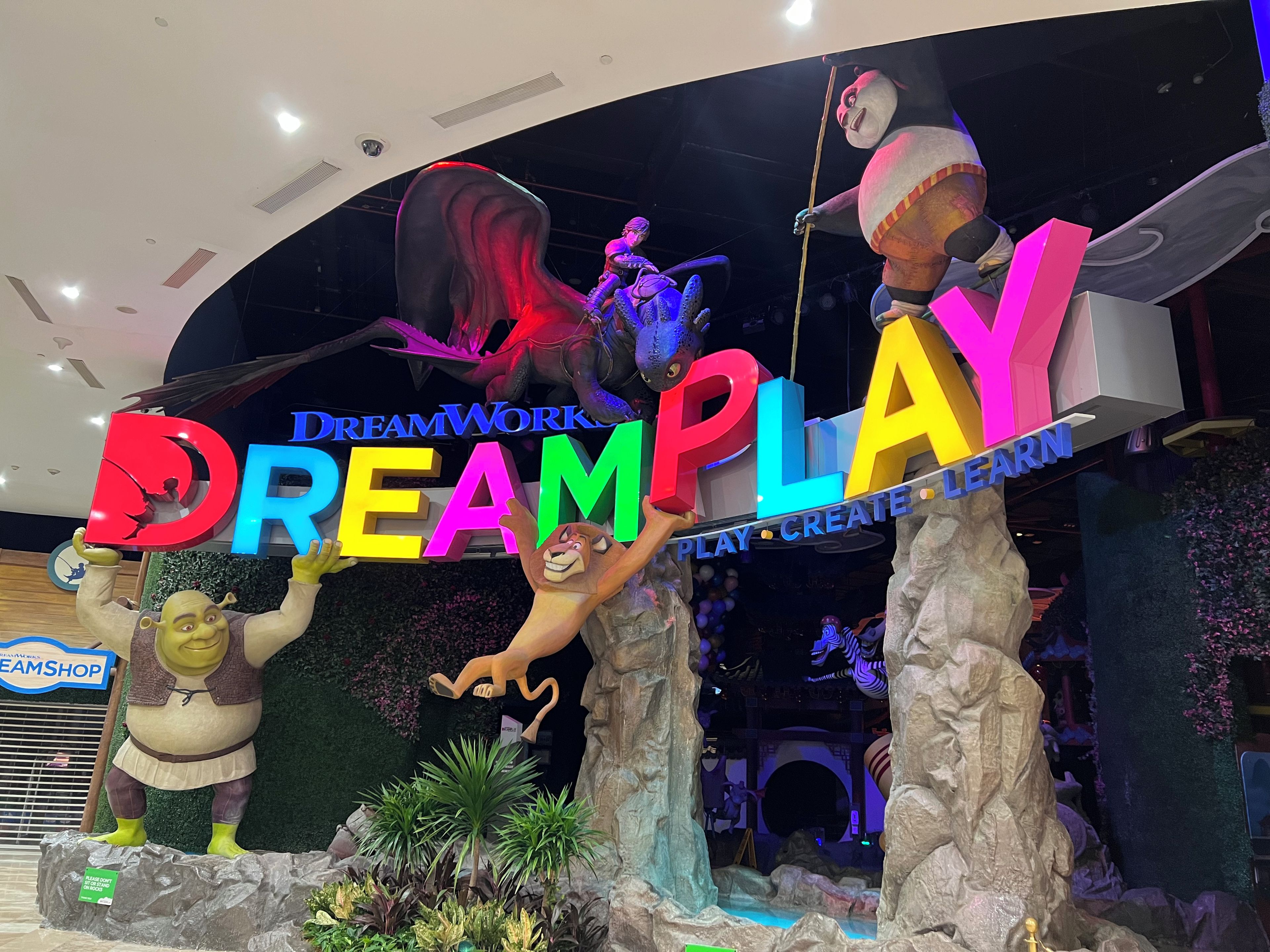 A large sign with the words 'DREAMPLAY' and 'PLAY CREATE LEARN' in a colorful display.