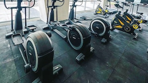 A gym with various exercise equipment including treadmills, stationary bikes, and weight machines. - Modern Cozy Sunlit Apt Next to AirportS (Parañaque)