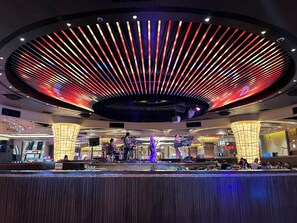 A modern interior with a circular ceiling design, a bar area, and seating arrangements. - Modern Cozy Sunlit Apt Next to AirportS (ParaƱaque)