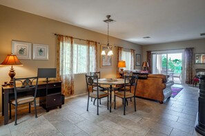 A well-lit living room with a dining area, a sofa, and a TV. - Desert-View Green Valley Retreat Near Golf Courses (Green Valley)