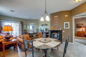 A living room with a dining table, chairs, a sofa, and a fireplace. - Desert-View Green Valley Retreat Near Golf Courses (Green Valley)