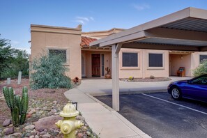 A residential building with a covered driveway, a fire hydrant, and a cactus in the landscaping. - Desert-View Green Valley Retreat Near Golf Courses (Green Valley)