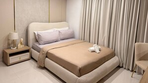 Una camera da letto moderna con un letto, un comodino, una lampada e una sedia.
