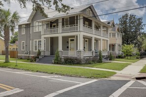 A two-story house with a front porch, a garage, and a driveway. - Historic Jacksonville Home: Near EverBank Stadium (Jacksonville)