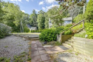 A residential property with a gravel pathway leading to a wooden staircase and a house with a gabled roof. - Pine Point: 3BR, 2BA, Private Dock & Kayaks! (Holland)