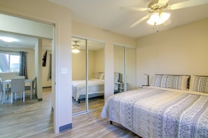 A bedroom with a bed, a desk, and a chair. There is a ceiling fan and a mirror. - See the Royal Gorge! Cañon City Apartment (Cañon City)