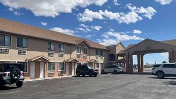 A motel with multiple rooms, a gas station, and a parking lot.