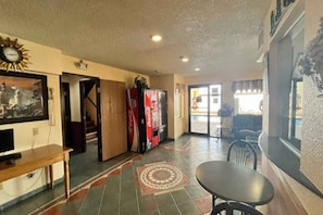 A hotel lobby with a reception desk, a seating area, and a Coca-Cola refrigerator. - 2 Queen Beds | Smoking, Micfridge (Deming NM)