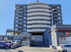 A multi-story parking garage with a central staircase leading to a building entrance. - Central Head Rest - Perfect Pop in spot (Cape Town)