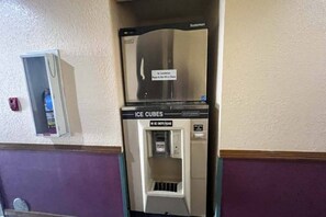 A vending machine with an 'Ice Cubes' label, a 'No Ice Chests Please' sign, and a 'Please Do Not Fill Ice Chests' notice.