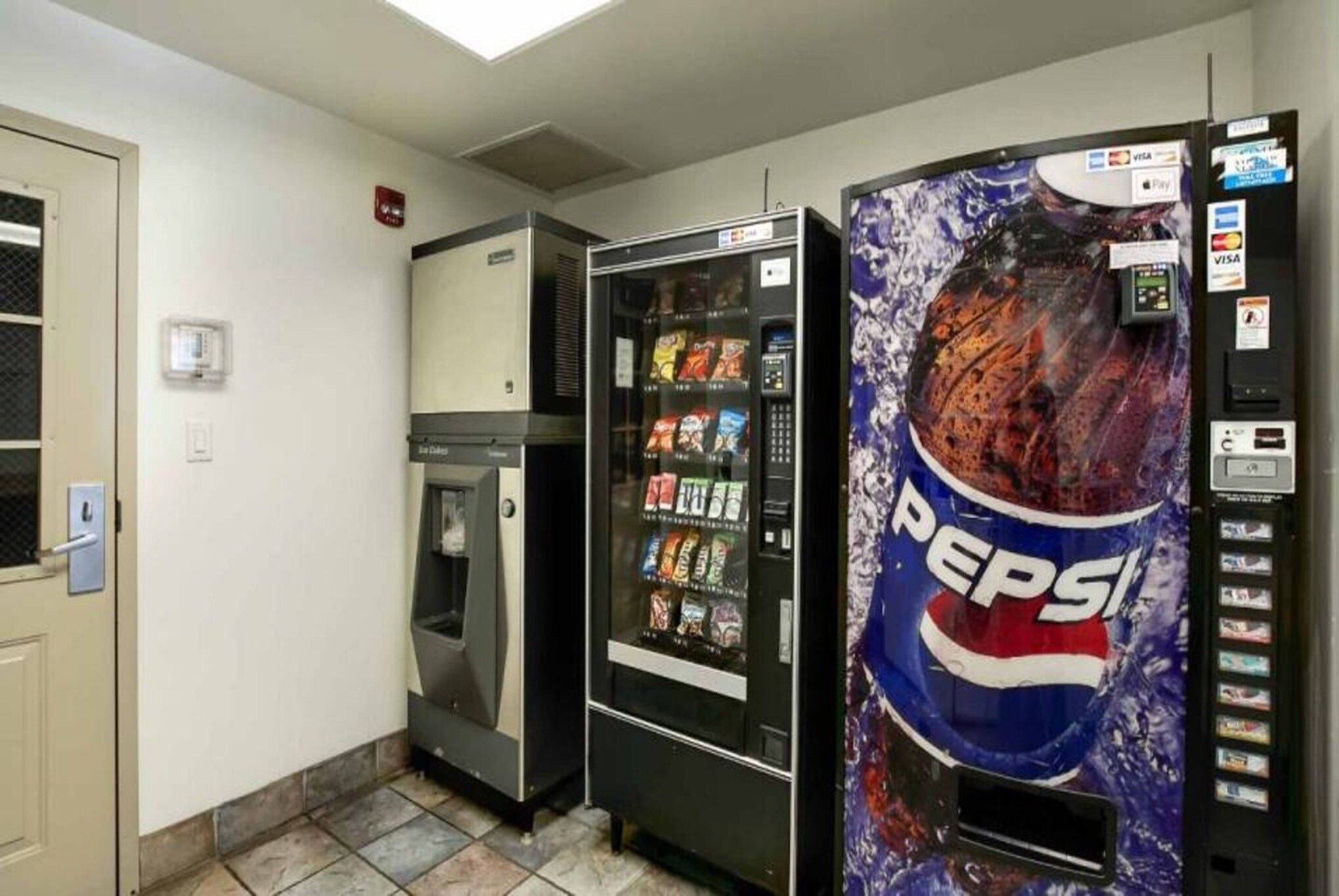 A vending machine area with a Pepsi dispenser and a microwave.