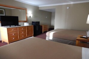 A hotel room with two beds, a dresser, a television, and a desk with a lamp. - 2 Queen Beds | Nsmk, Micfridge (Lawrenceville)